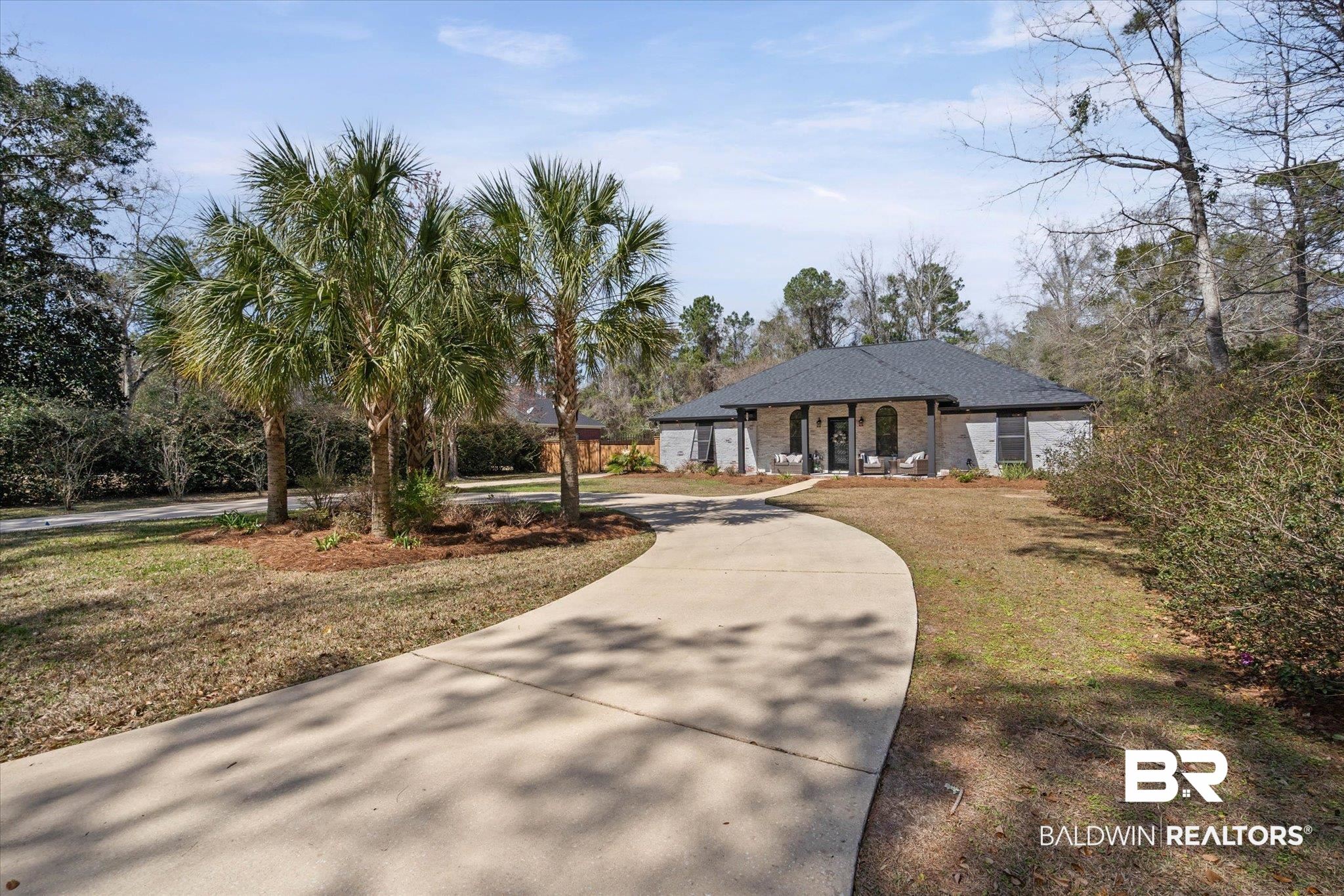 3216 Bay Booster Club Road Theodore, AL 36582 - Photo 30 of 46 View of front of home with brick siding, curved driveway, a front yard, and a porch