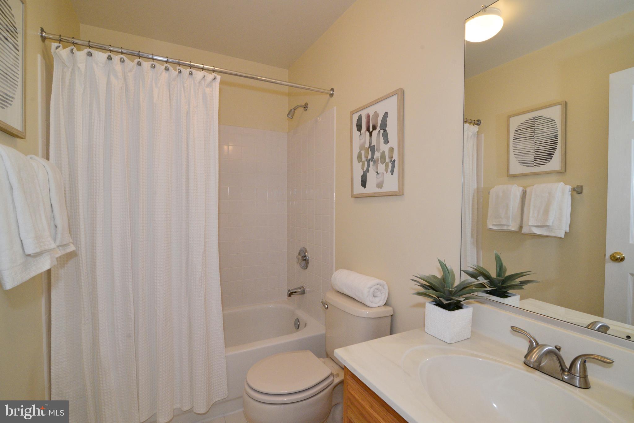 1384 Park Garden Lane Reston, VA 20194 - Photo 30 of 38 Full hall bathroom with a ceramic tile shower/tub.