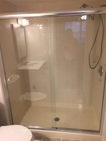 a bathroom with a shower and a toilet