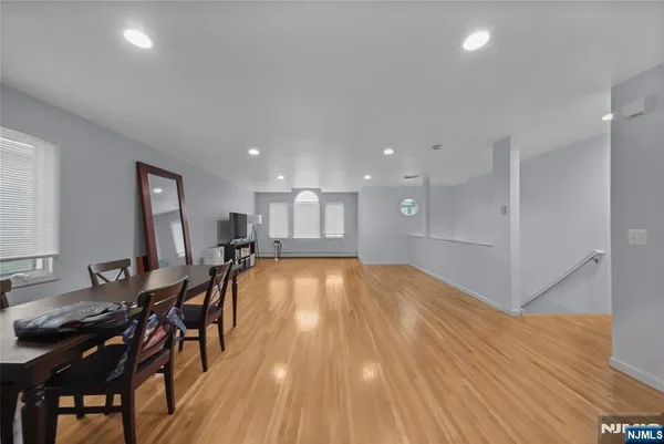 a view of a big room with wooden floor and lounge chairs