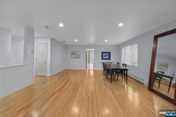 a view of a room with dining room and wooden floor