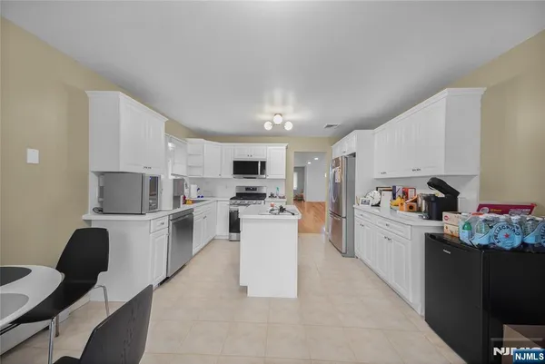 a kitchen with cabinets and white appliances