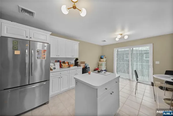 a kitchen with white cabinets and white appliances