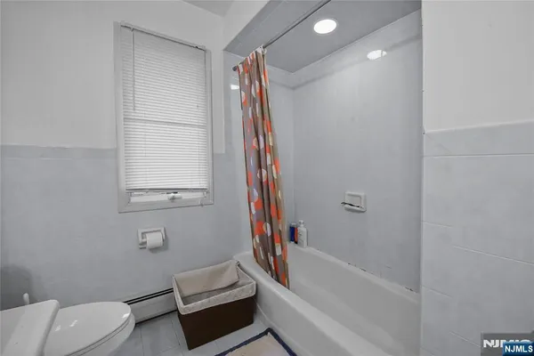 a bathroom with a toilet and a bathtub