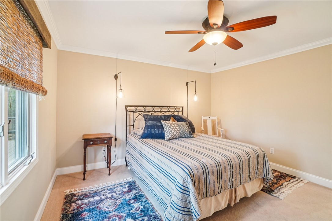 120 Beacon Ridge Circle Salem, SC 29676 - Photo 30 of 49 This inviting bedroom features crown molding, a ceiling fan, and carpeted floors, creating a comfortable living space.