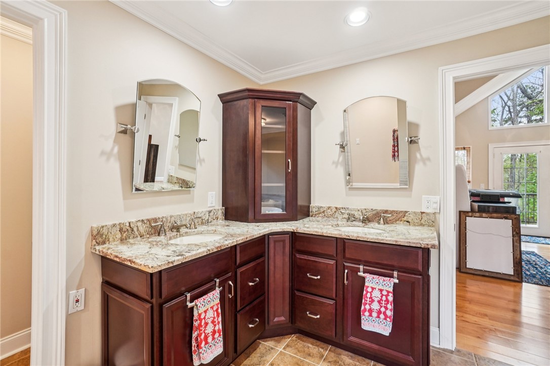 120 Beacon Ridge Circle Salem, SC 29676 - Photo 34 of 49 This bathroom offers a large double vanity with granite counters and rich wood cabinetry.