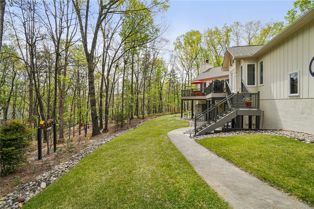 120 Beacon Ridge Circle Salem, SC 29676 - Photo 41 of 49 This residence features a deck and a gracefully winding pathway, nestled beside a lush forest.