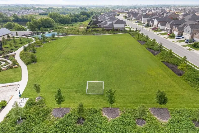 an aerial view of a house with a yard