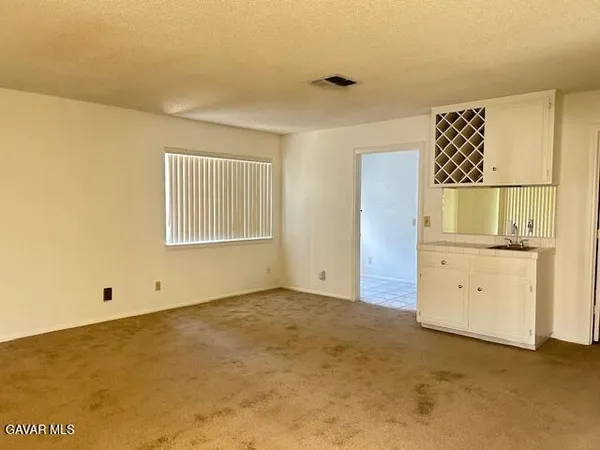 a kitchen with stainless steel appliances white cabinets a stove and a microwave