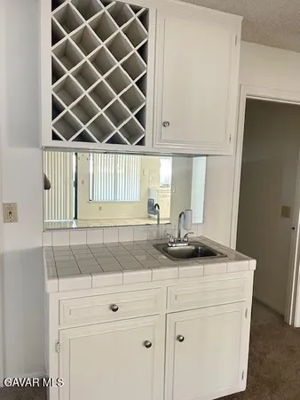 a stove top oven sitting inside of a kitchen