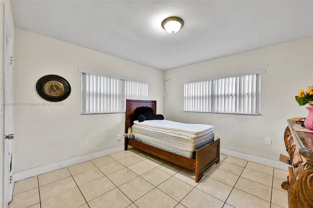 a spacious bedroom with a bed and a window
