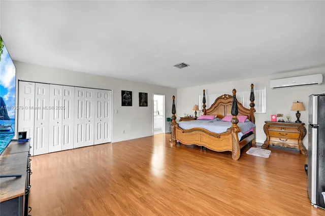 a bedroom with furniture and wooden floor