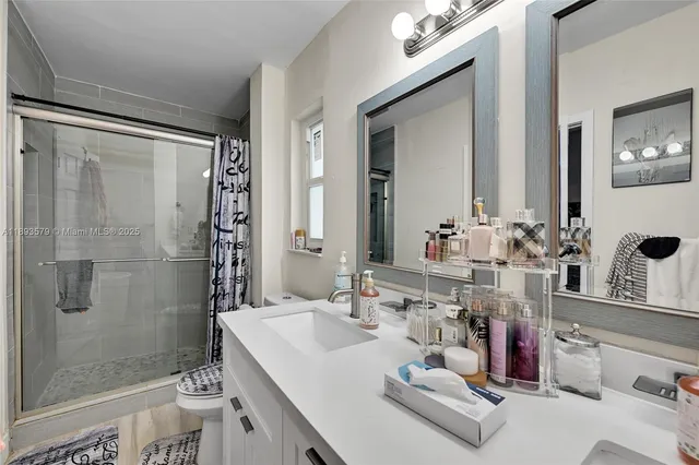 a bathroom with a sink double vanity and shower