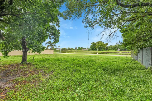 a big yard with lots of green space and trees