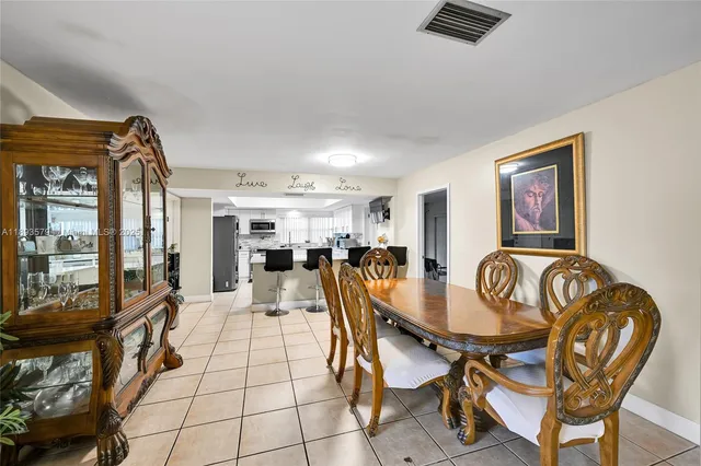 a view of a dining room with furniture and chandelier