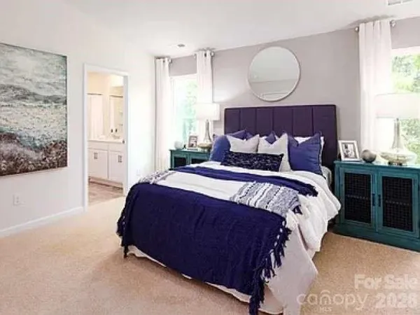 a bedroom with bed and wooden floor
