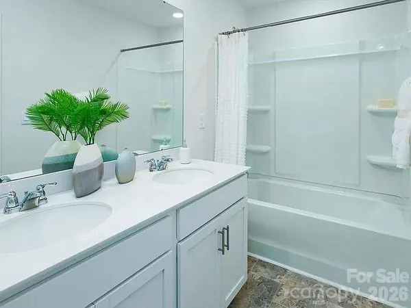 a bathroom with a sink a mirror and a shower