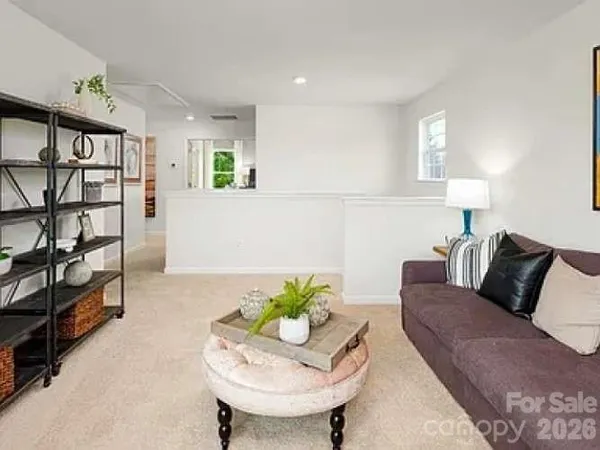 a living room with furniture and a book shelf