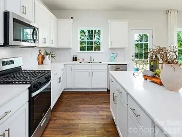 a kitchen with stainless steel appliances granite countertop a stove and a sink