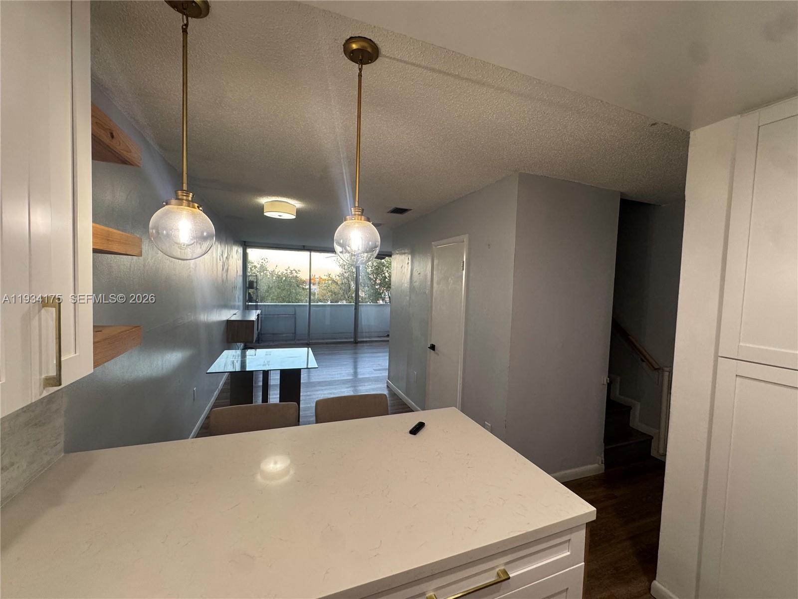 1750 West 56th Street, Unit 211 Hialeah, FL 33012 - Photo 12 of 19 a large kitchen with a table and chairs