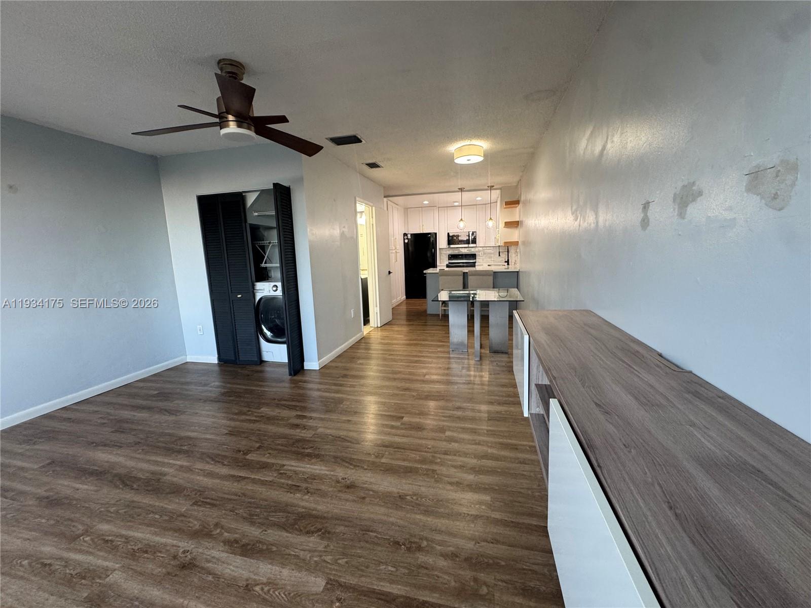 1750 West 56th Street, Unit 211 Hialeah, FL 33012 - Photo 14 of 19 a view of a living room a dining room wooden floor and a window