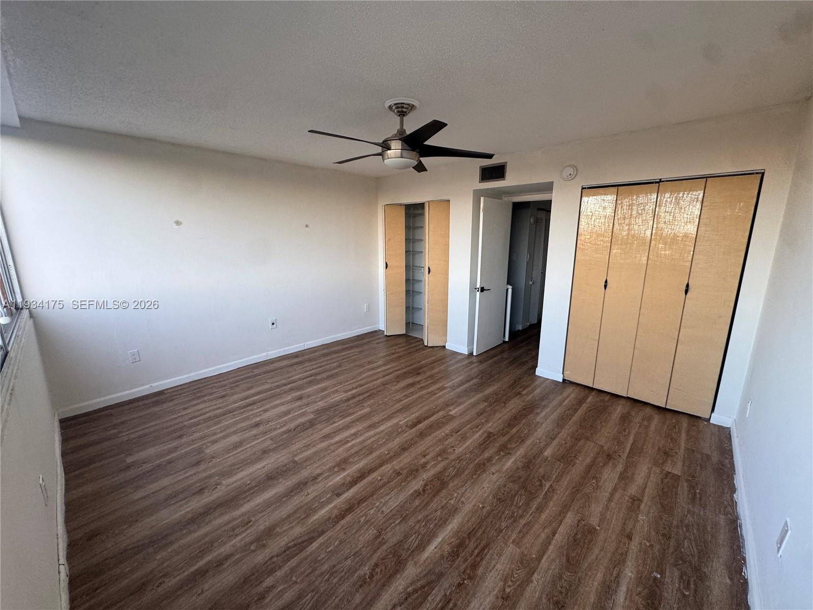 1750 West 56th Street, Unit 211 Hialeah, FL 33012 - Photo 17 of 19 wooden floor in an empty room with a window