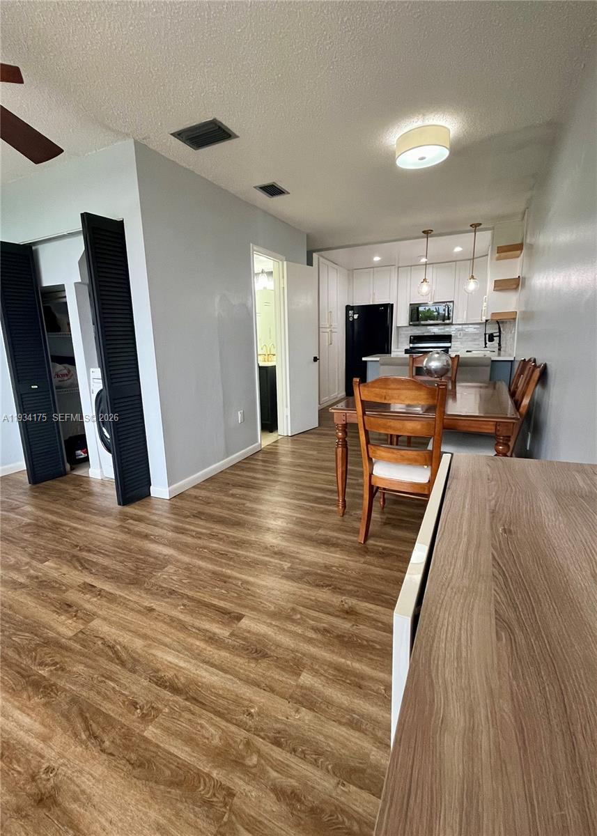 1750 West 56th Street, Unit 211 Hialeah, FL 33012 - Photo 5 of 19 a view of a living room with furniture and a flat screen tv