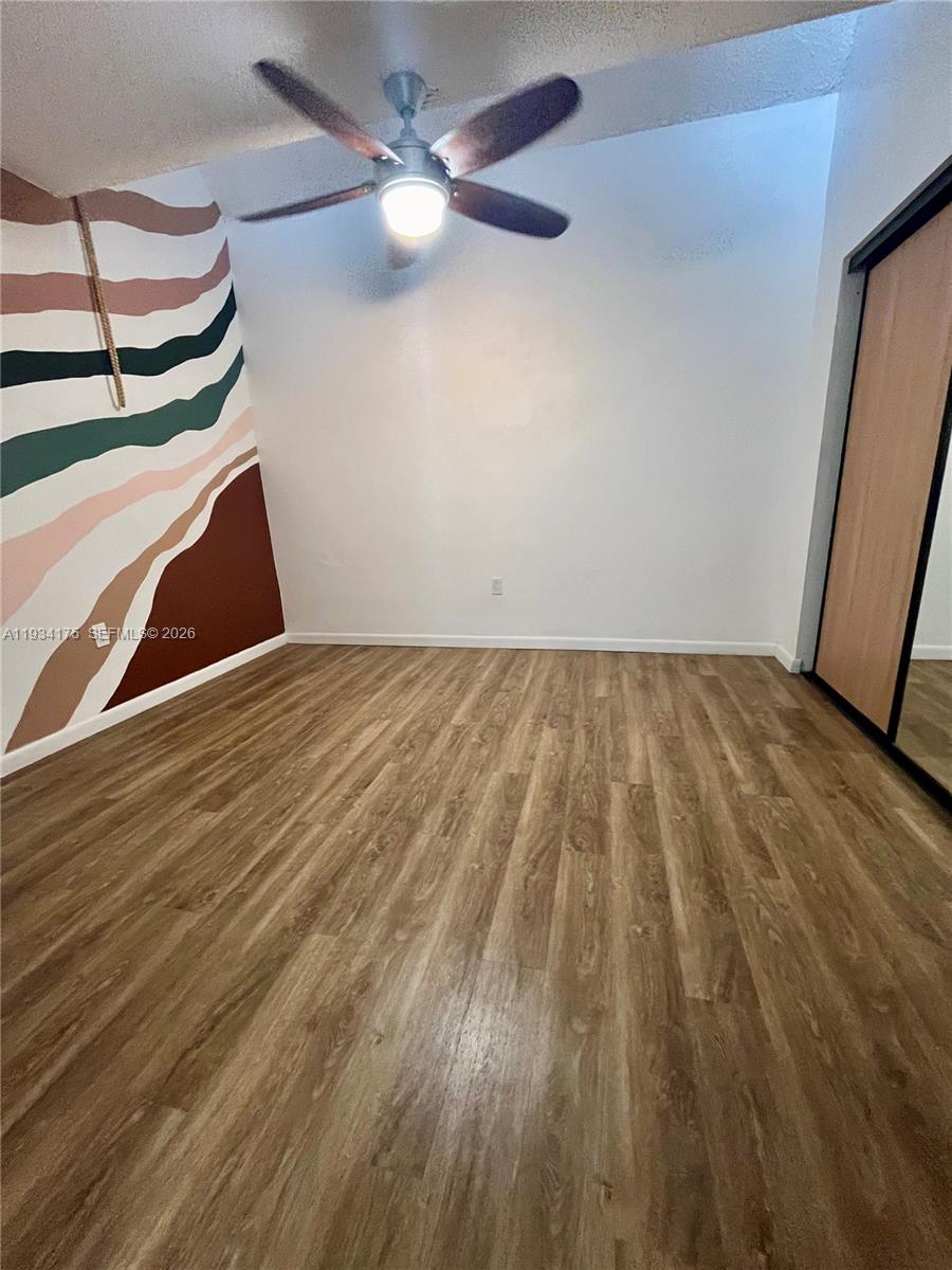 1750 West 56th Street, Unit 211 Hialeah, FL 33012 - Photo 9 of 19 a view of empty room with wooden floor
