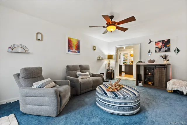 a living room with furniture a rug and a window