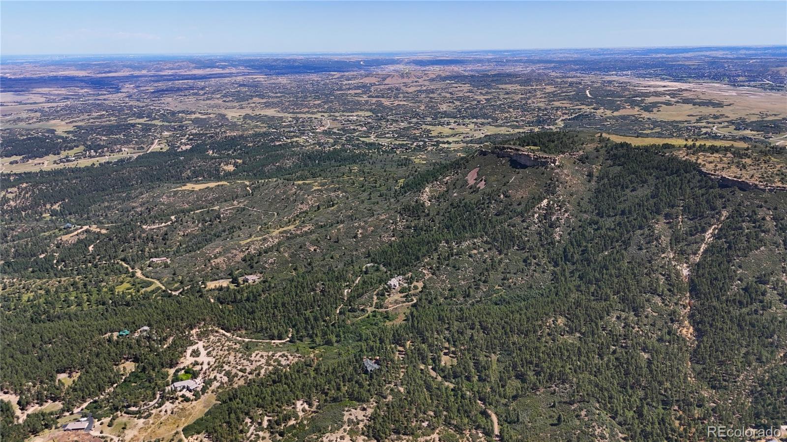 5080 South Perry Park Road Sedalia, CO 80135 - Photo 12 of 39 an aerial view of residential houses with outdoor space
