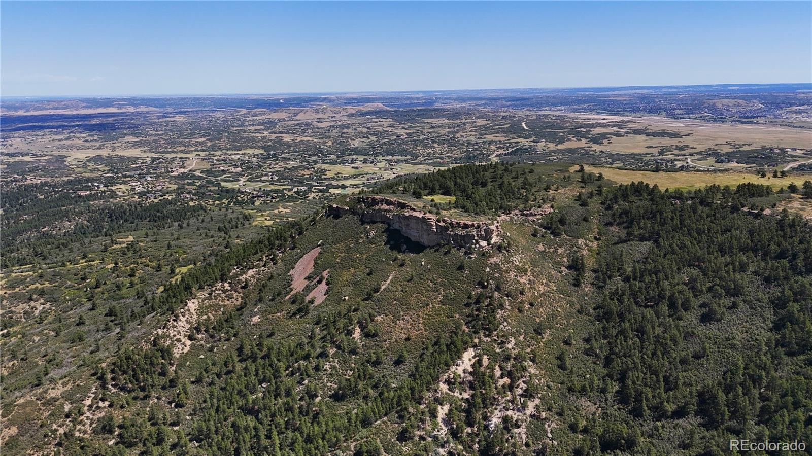5080 South Perry Park Road Sedalia, CO 80135 - Photo 14 of 39 a view of a city with lush green forest