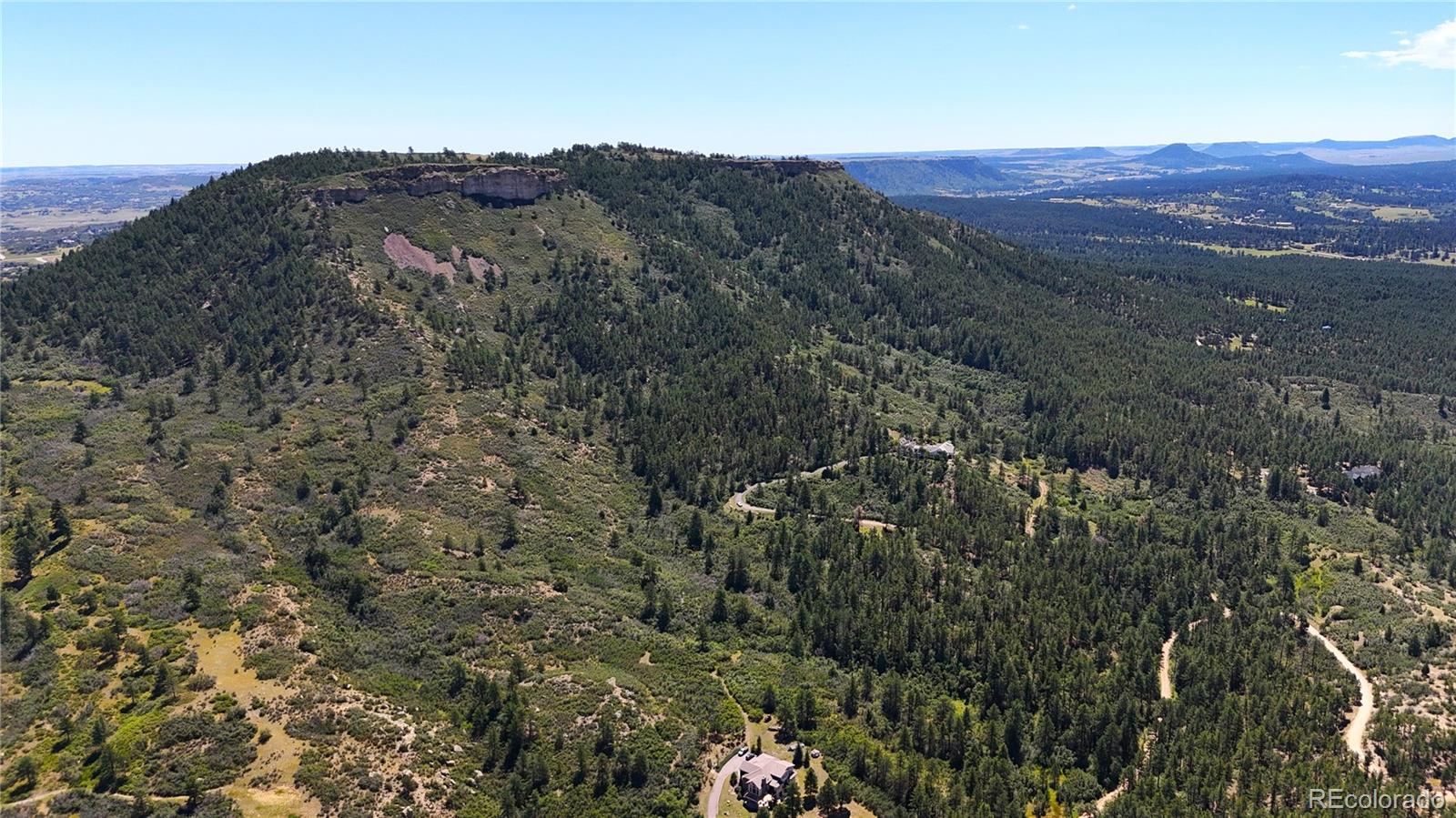5080 South Perry Park Road Sedalia, CO 80135 - Photo 22 of 39 a view of a mountain range with trees in the background