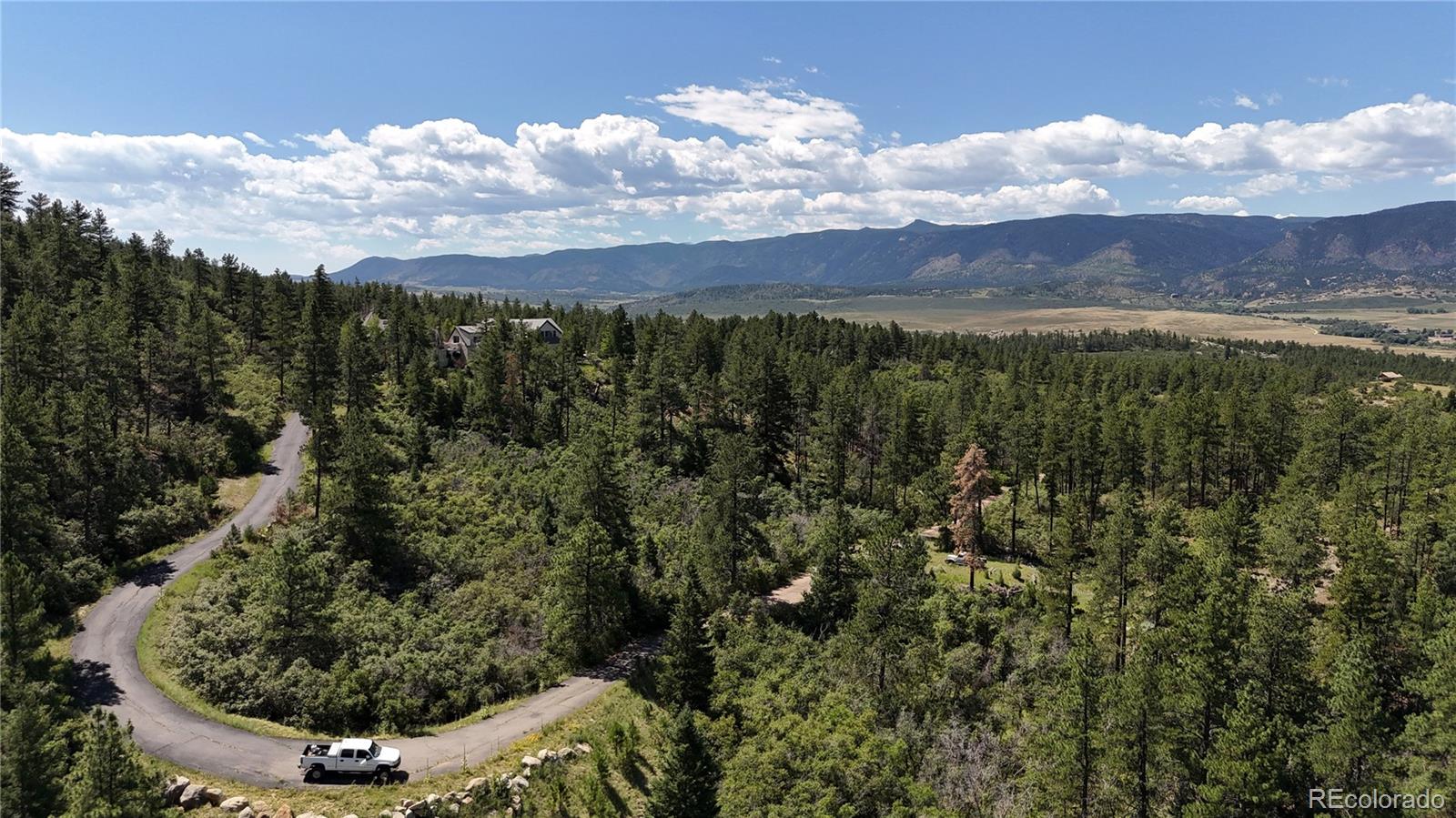5080 South Perry Park Road Sedalia, CO 80135 - Photo 32 of 39 a view of a city with lush green forest
