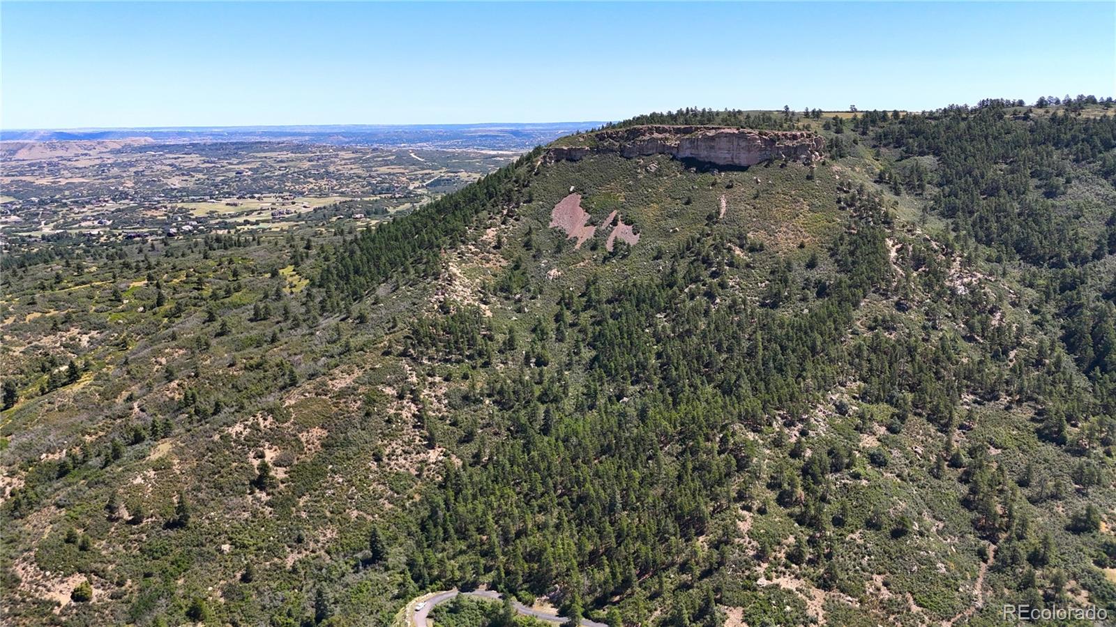 5080 South Perry Park Road Sedalia, CO 80135 - Photo 36 of 39 a view of a city with lush green forest