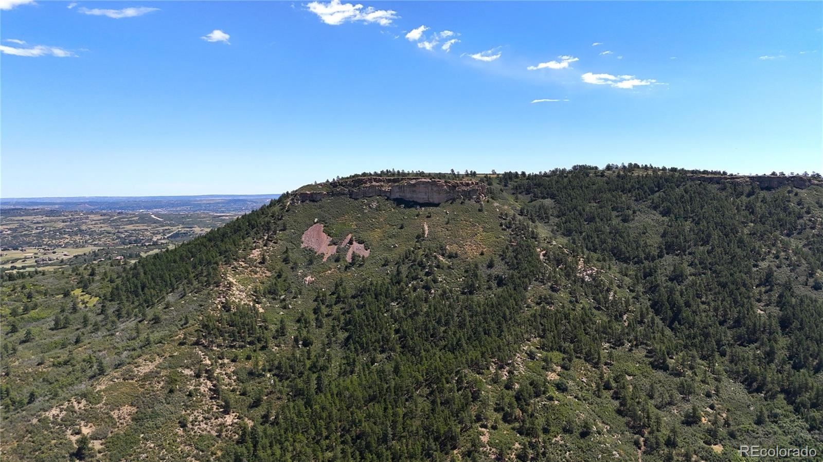5080 South Perry Park Road Sedalia, CO 80135 - Photo 37 of 39 an aerial view of mountain with tree in the background