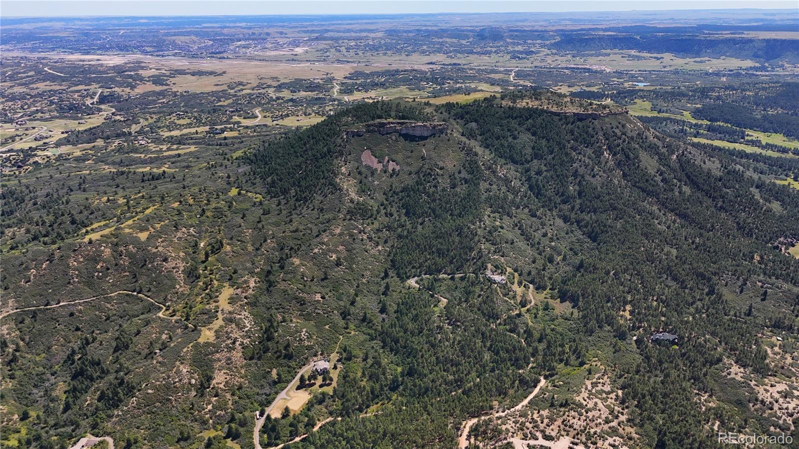 5080 South Perry Park Road Sedalia, CO 80135 - Photo 4 of 39 an aerial view of residential house and green space
