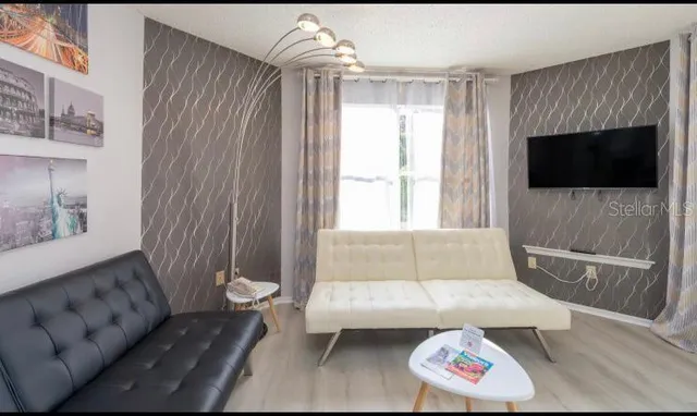 a living room with furniture and a flat screen tv