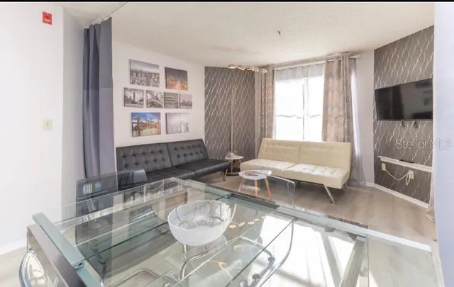 a living room with furniture and a flat screen tv