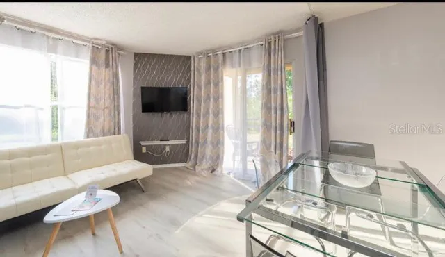 a living room with furniture and a painting on the wall