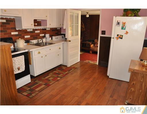 27 Colton Road Edison, NJ 08817 - Photo 3 of 9 a kitchen that has a refrigerator and a stove