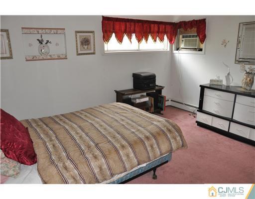 27 Colton Road Edison, NJ 08817 - Photo 7 of 9 a bedroom with a bed and a desk