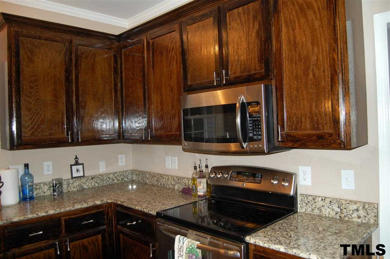 9505 Meadowmont Lane Raleigh, NC 27615 - Photo 13 of 18 a kitchen with granite countertop a stove and cabinets