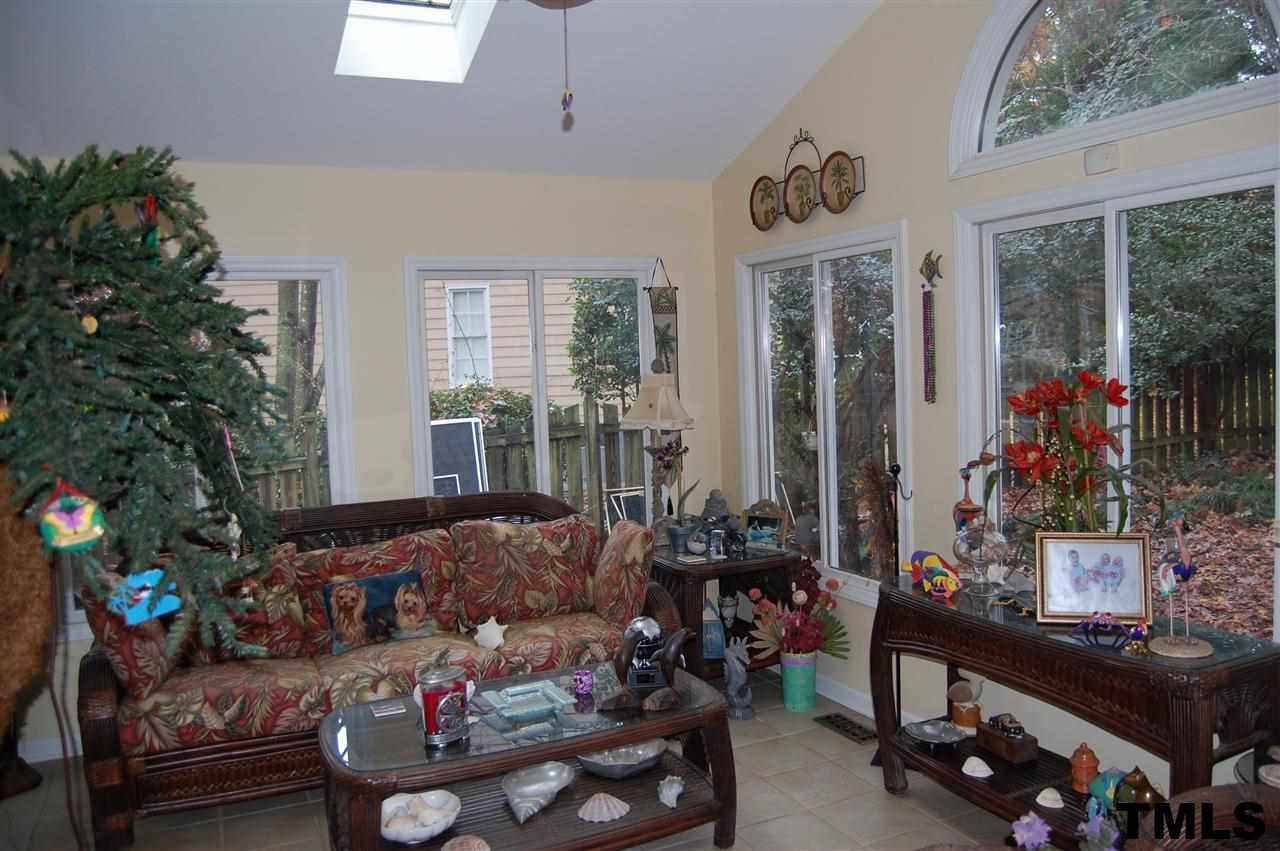 9505 Meadowmont Lane Raleigh, NC 27615 - Photo 17 of 18 a living room filled with lots of furniture and a floor to ceiling window