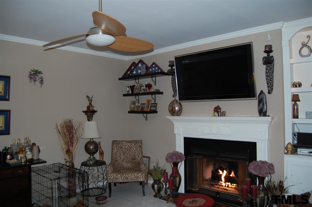 9505 Meadowmont Lane Raleigh, NC 27615 - Photo 9 of 18 a living room with furniture and a fireplace
