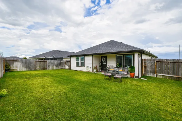 a view of a house with a yard porch and sitting area