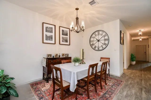 a view of a dining area with furniture and a clock