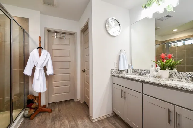 a bathroom with a granite countertop sink a vanity and a mirror