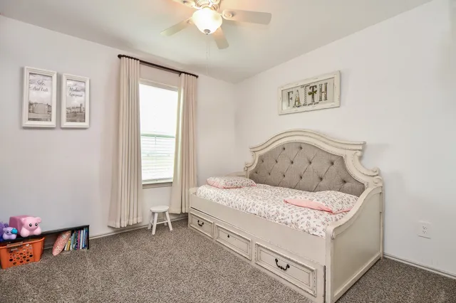 a bedroom with a bed a window and couch