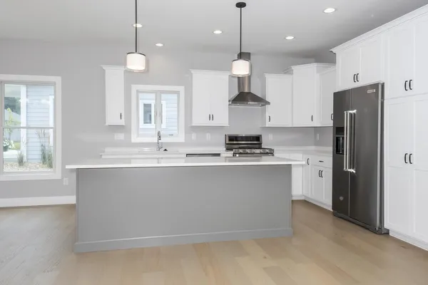 a kitchen with stainless steel appliances a sink stove and refrigerator