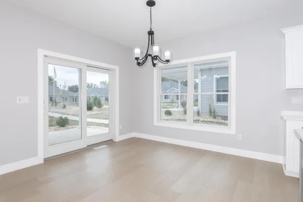 a view of a kitchen with large windows
